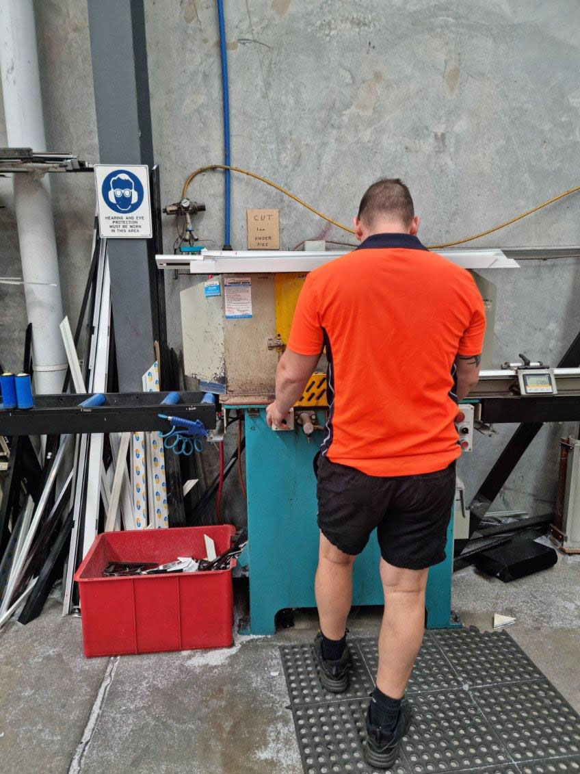 Aluminium frame extrusions being cut to length at the Securelux Redland Bay factory